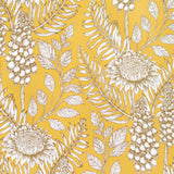 Detail of wallpaper in a dense floral print in black and white on a mustard field.