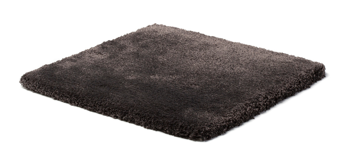 A square dark gray shag rug with a plush, high-pile texture, shown from an elevated perspective on a plain white background.