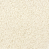 A close-up texture shot of a handtufted rug, showing the looped pile texture in a solid cream color.