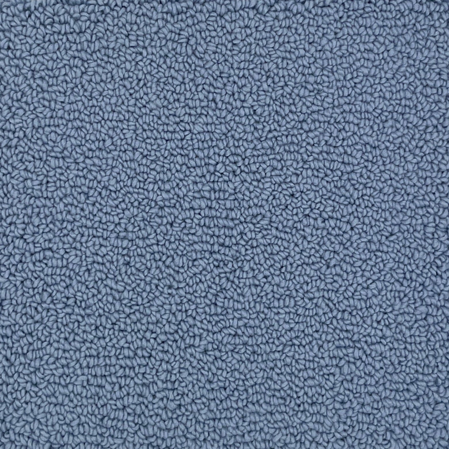 A close-up texture shot of a handtufted rug, showing the looped pile texture in a solid medium blue color.