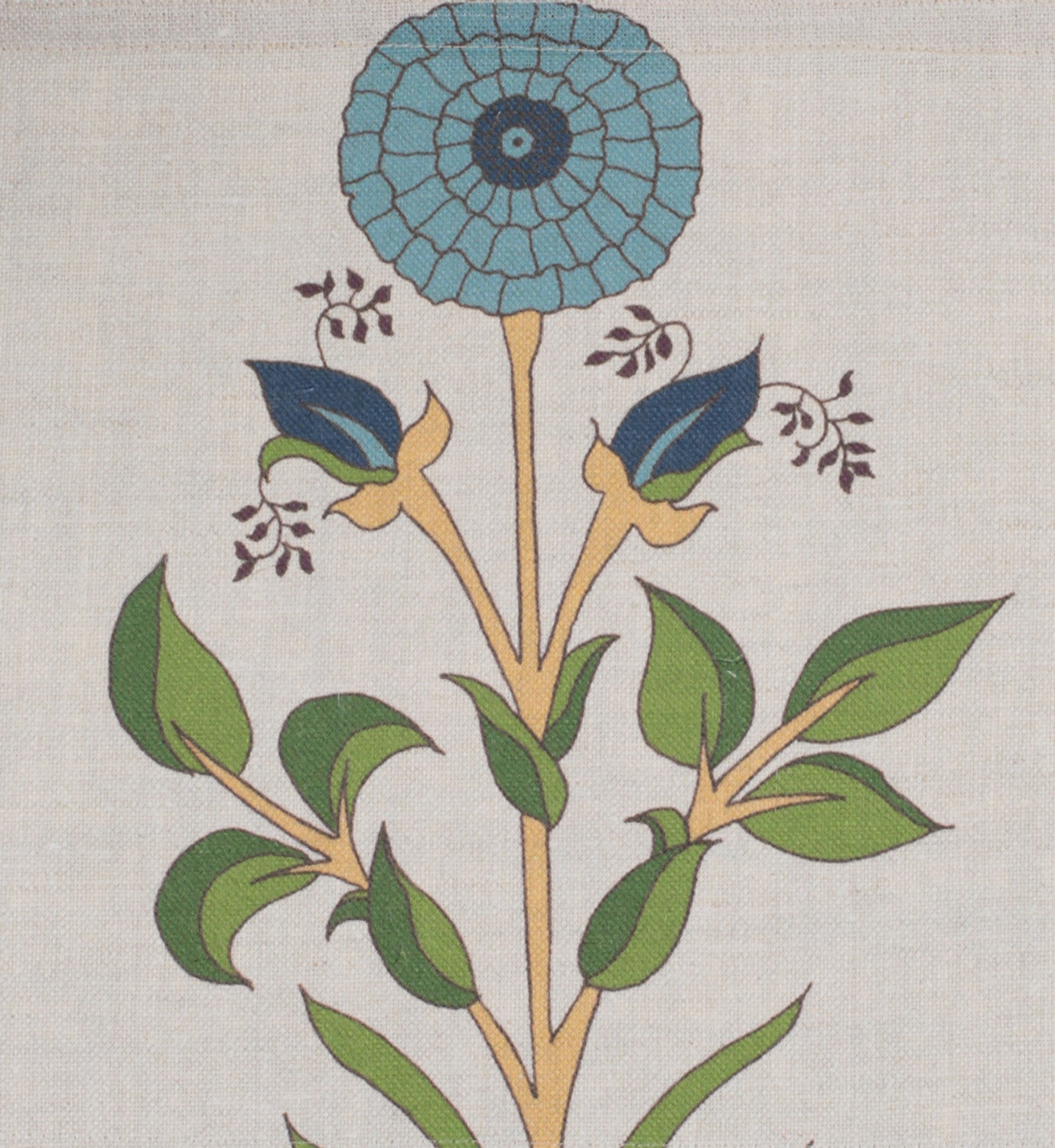 Detail of fabric in a large-scale marigold print in blue, orange and green on a cream field.