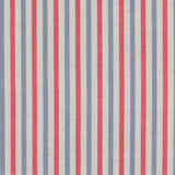 Detail of fabric in a small-scale stripe print in red and blue on a cream field.