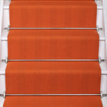 Striped flatweave runner in orange on white staircase