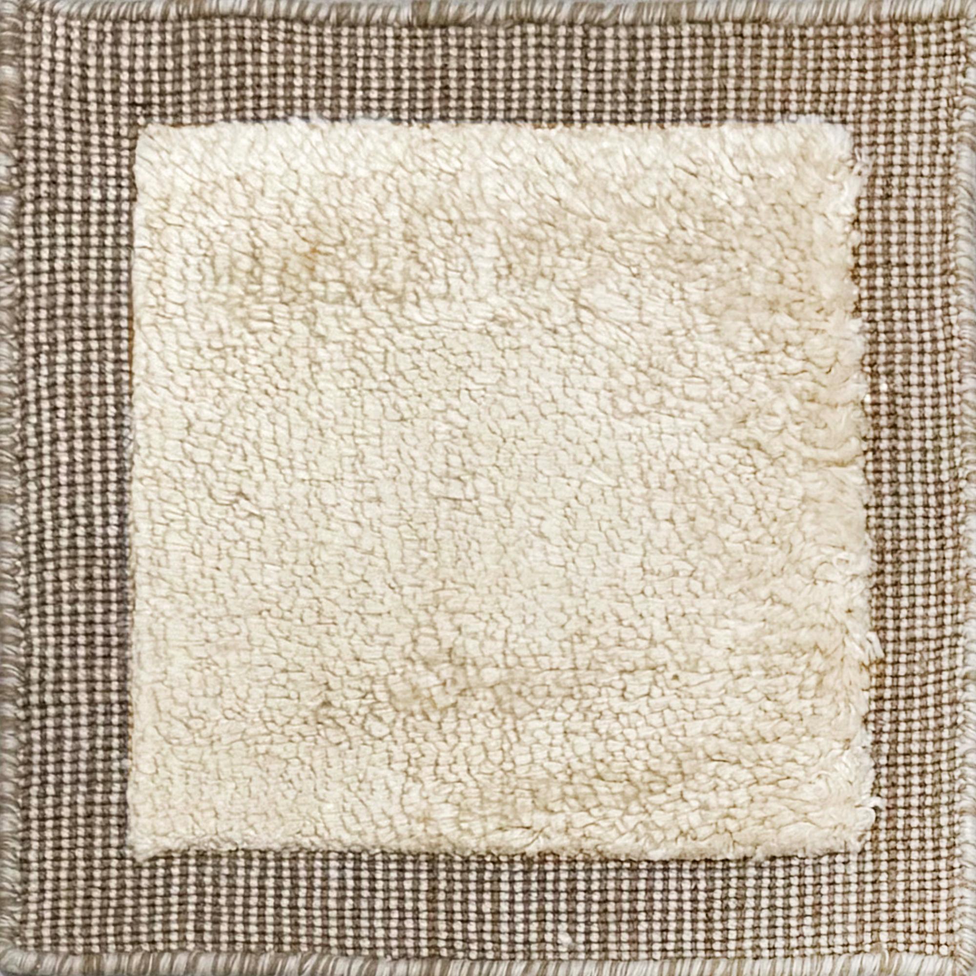 Handloomed rug with neutral border and raised cut pile shag field in beige. 