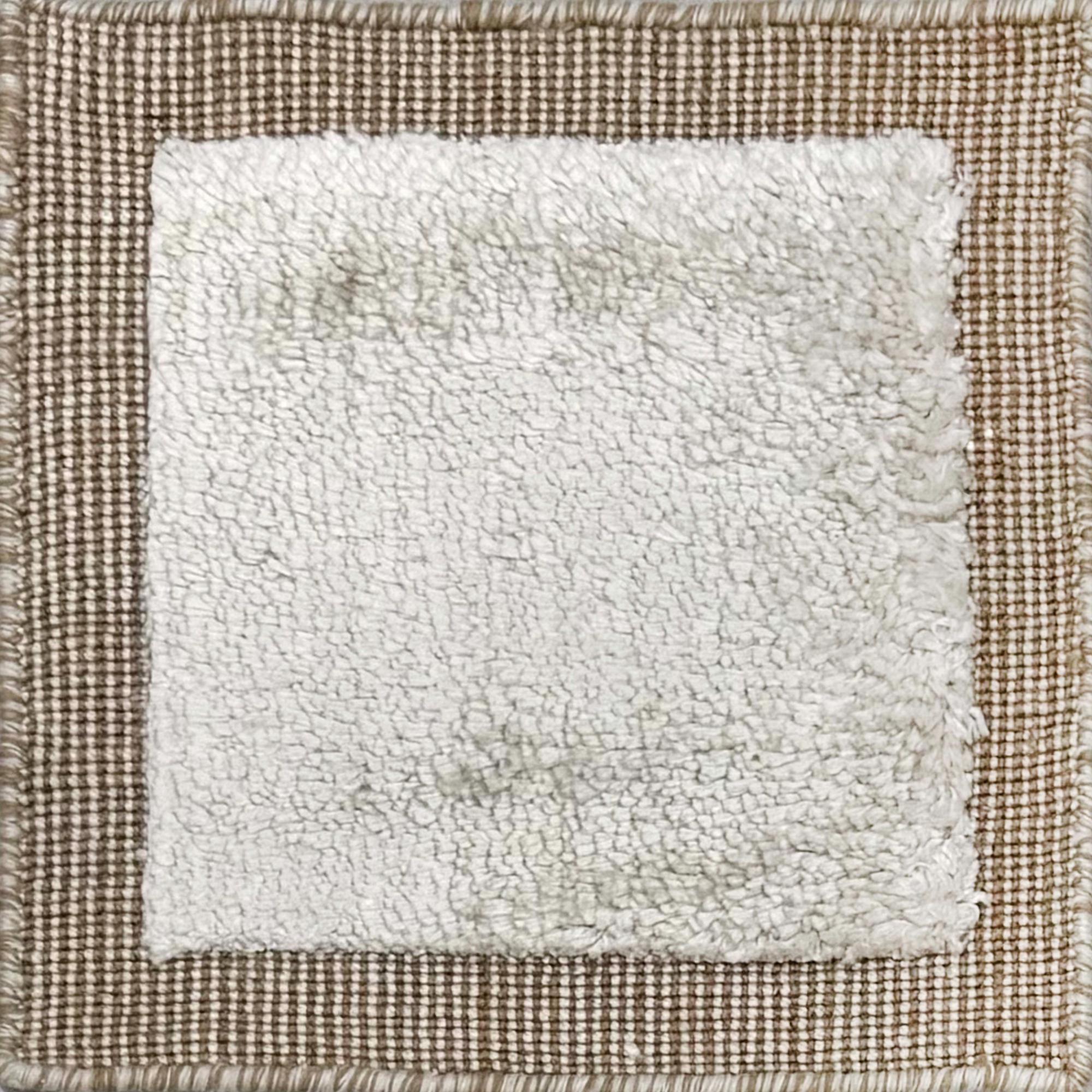 Handloomed rug with neutral border and raised cut pile shag field in grey. 