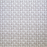 Detail of fabric in a floral grid print in white on a mauve field.