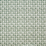 Detail of fabric in a floral grid print in white on a forest green field.