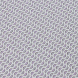 Detail of a wallpaper panel in a linear geometric print in shades of purple and navy on a light blue field.