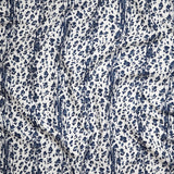 Close up of gently draped Indoor-Outdoor fabric with a painterly animal print in dark blue on white. 