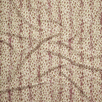 Close up of gently draped printed linen with small scale painterly animal print in mauve and olive green on a beige background