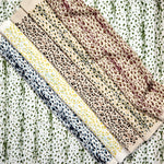 Gently draped fabric cuttings painterly animal print in various colors. 