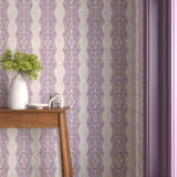 Interior with purple geometric wallpaper and matching trim with a wooden console table with white ceramic vases with flowers. 