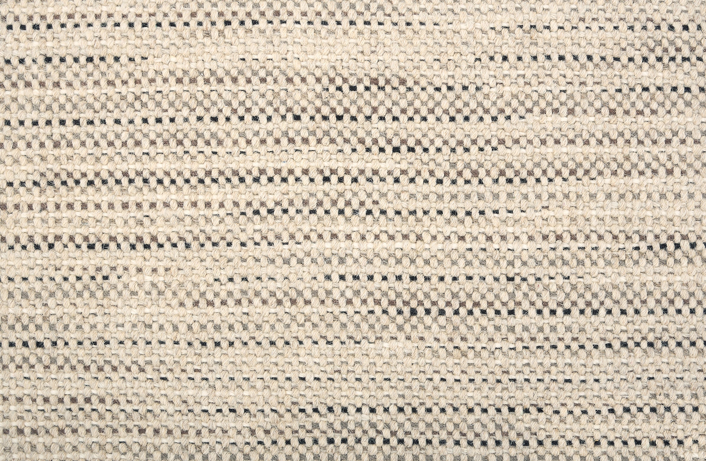 Broadloom carpet in a textural strie stripe oatmeal with accents of black, grey and brown.