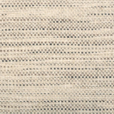 Broadloom carpet in a textural strie stripe oatmeal with accents of black, grey and brown.