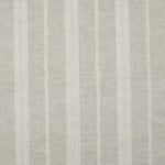 Detail of fabric in a small-scale botanical stripe print in cream on a tan field.