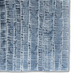 Detail of a hand-painted wallpaper swatch with an undulating ribbon pattern in navy on a silver field.