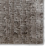 Detail of a hand-painted wallpaper swatch with an undulating ribbon pattern in charcoal on a silver field.