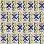 Close up printed wallpaper with green squiggles, white striped triangles, blue X marks on a broken grid in orange on a white background. 