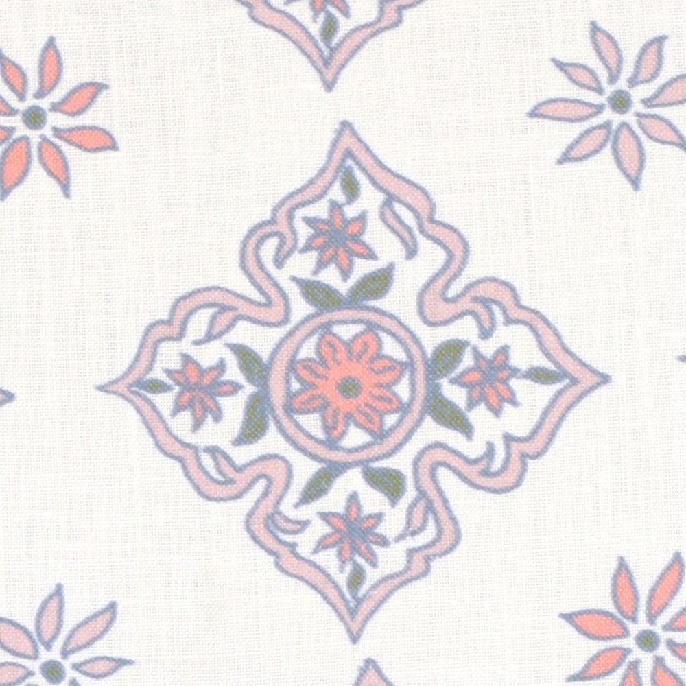 Detail of fabric in a diamond damask print in shades of pink, purple, blue and green on a cream field.