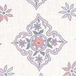 Detail of fabric in a diamond damask print in shades of pink, purple, blue and green on a cream field.