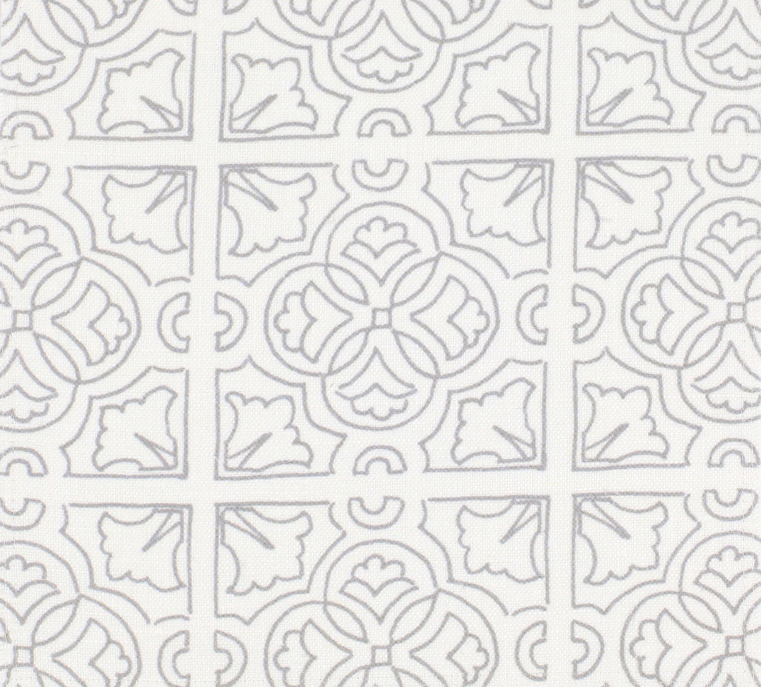 Detail of fabric in a damask lattice print in light gray on a white field.
