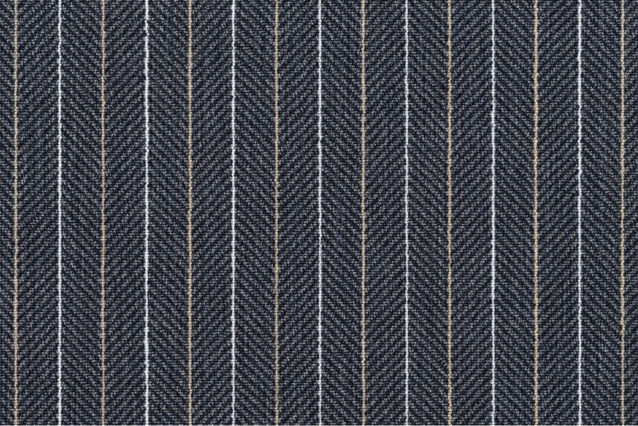 Broadloom carpet in a charcoal herringbone stripe with white and tan pinstripes. 