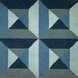 Geometric patterned rug with blue and gray triangles