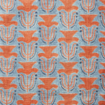 Fabric swatch with a stamped painted floral motif in red and cobalt on a medium blue background