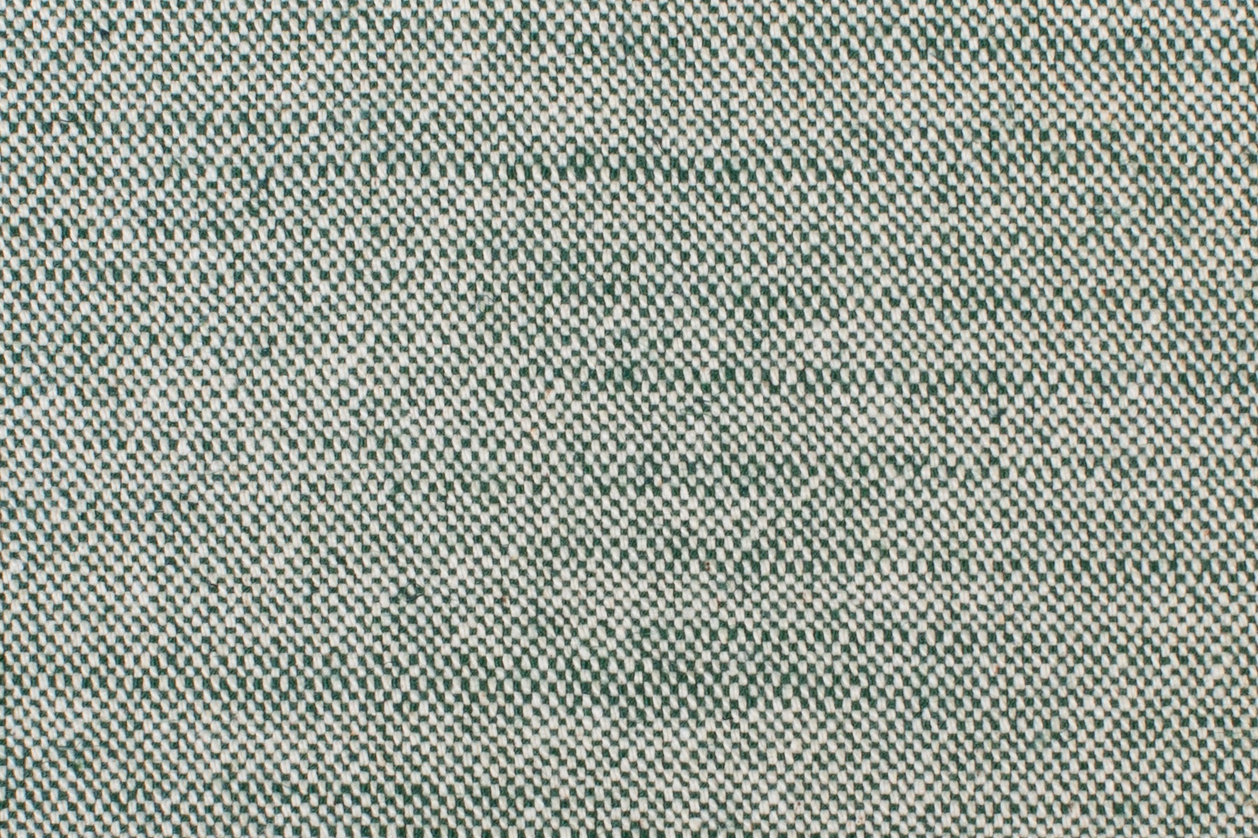 Detail of woven fabric yardage in textured cream and dark green.