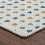 Patterned rug with multicolored dots on a wooden floor