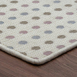 Patterned rug with multicolored dots on a wooden floor