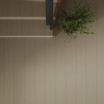 Overhead image of a staircase and landing with a potted plant  and wall to wall herringbone carpet in beige with pink accent stripes. 