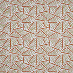 Printed fabric detail in a playful dot and line pattern in soft green and burnt orange