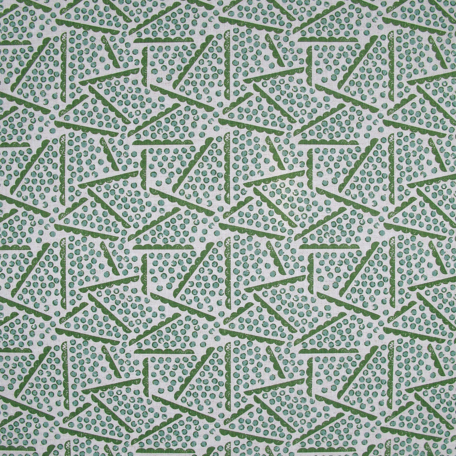 Printed fabric detail in a playful dot and line pattern in  acqua and grass green