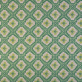 Detail of fabric in a playful floral grid print in green, yellow and blue on a white field.
