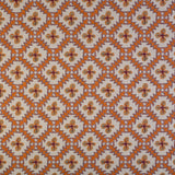 Detail of fabric in a playful floral grid print in orange, purple and green on a white field.