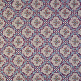 Detail of fabric in a playful floral grid print in blue, pink and purple on a white field.