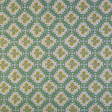Detail of fabric in a playful floral grid print in green, yellow and blue on a white field.