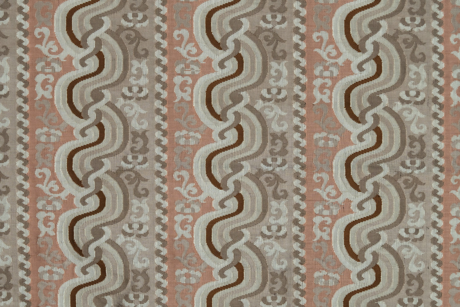 Handwoven silk fabric with scrolling stripe design in pink, beige, brown and white. 