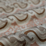 Close-up of textured fabric with wavy pattern on a pink background