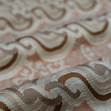 Close-up of textured fabric with wavy pattern on a pink background