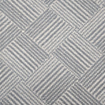 Broadloom rug sample in a diamond pattern in stripes of white and slate blue.