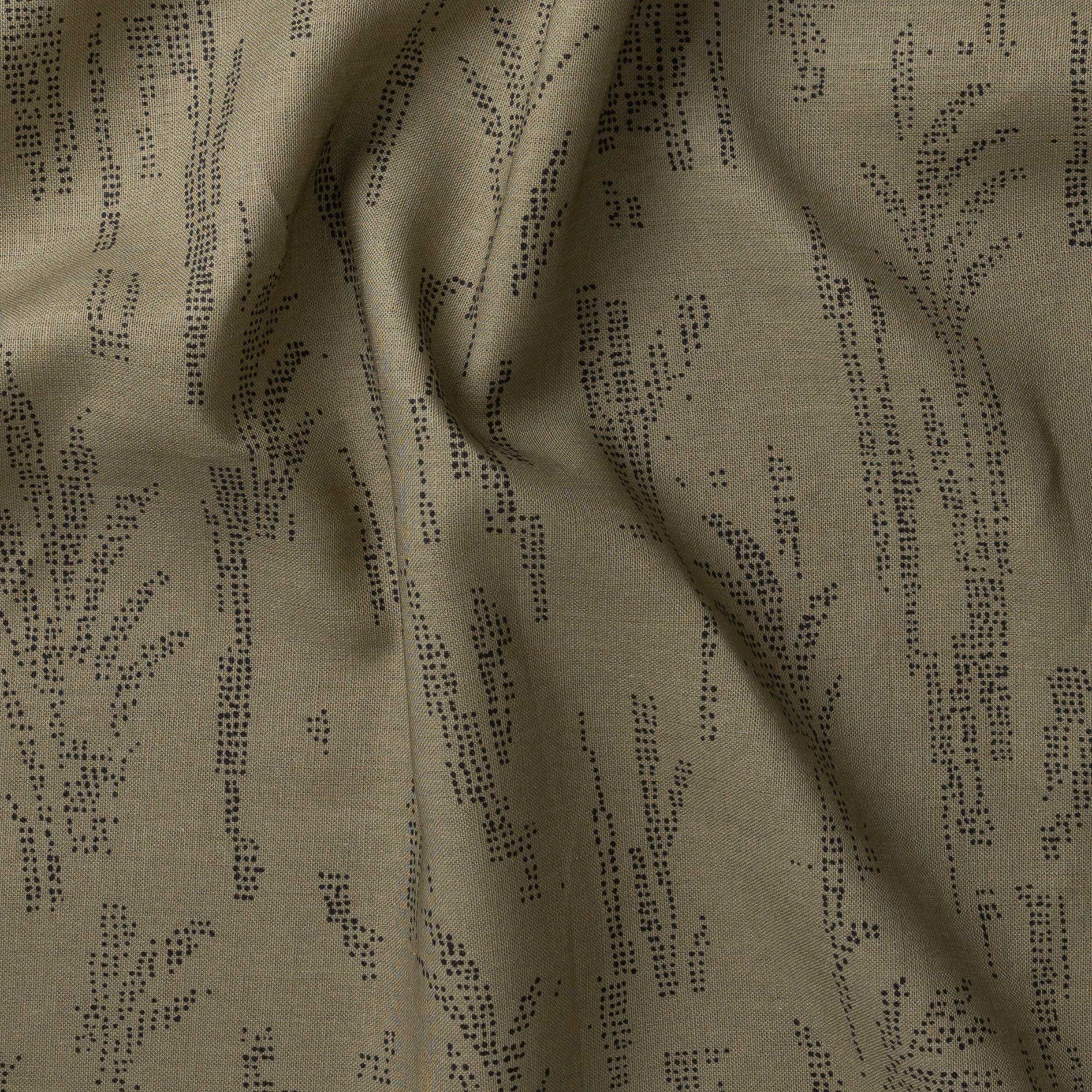 Detail of gently draped printed fabric with a black pointillist wheat frond pattern on a sage green background. 