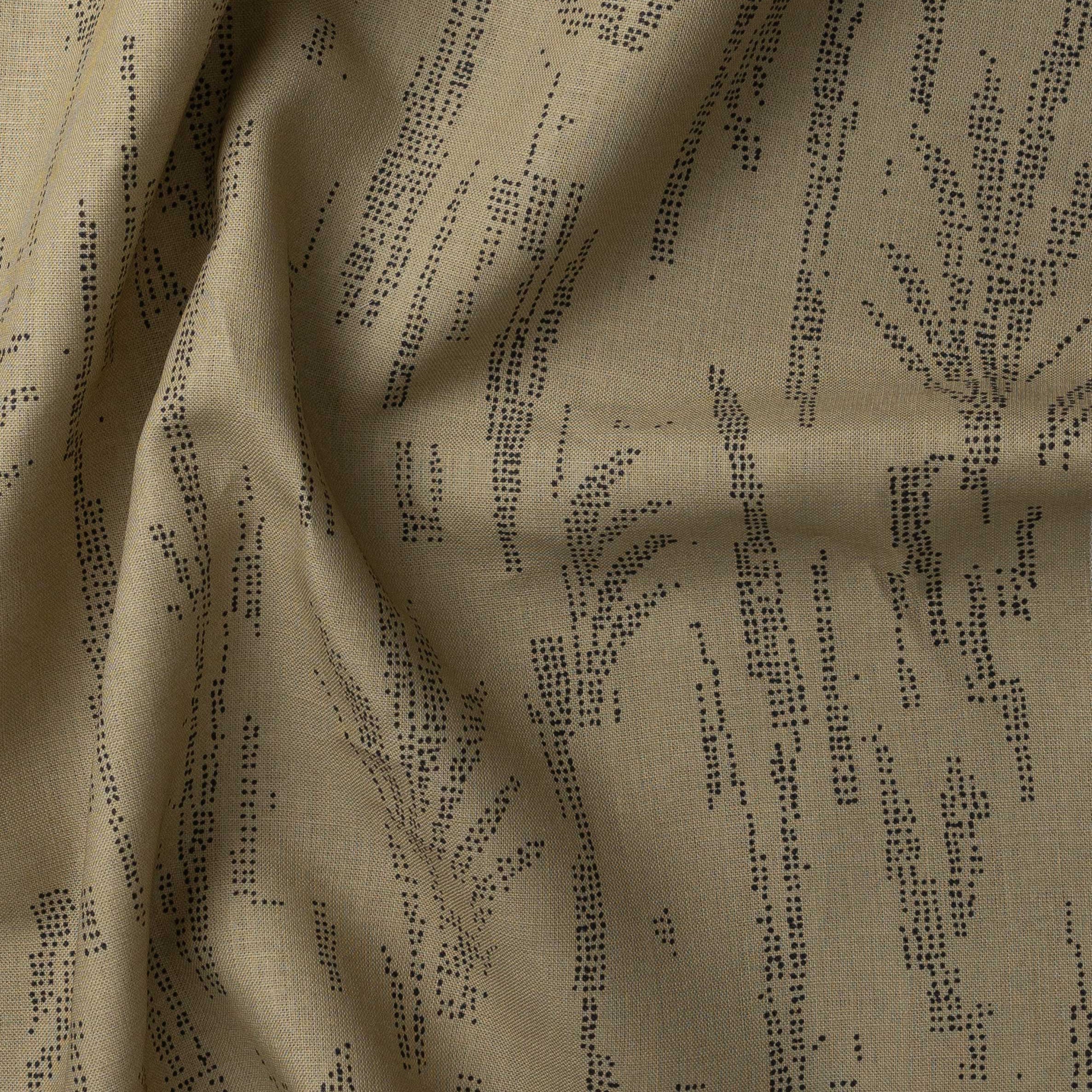 Detail of gently draped printed fabric with a black pointillist wheat frond pattern on a muted ochre background. 