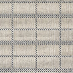 Broadloom carpet detail in plaid grid in shades of blue on a beige field.