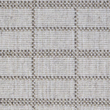 Broadloom carpet detail in plaid grid in shades of brown on a beige field.