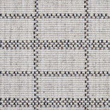 Broadloom carpet detail in plaid grid in shades of blue and brown on a beige field.