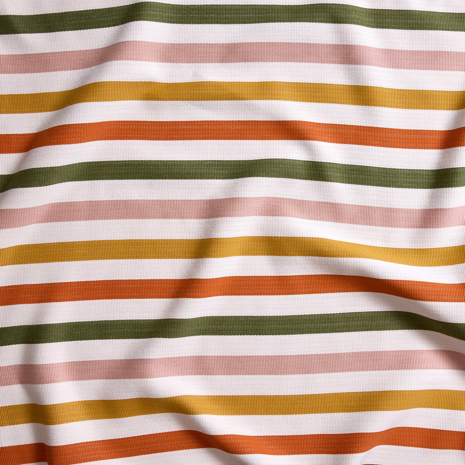 Close up of gently draped striped woven Indoor-Outdoor fabric in white, olive green, pink, mustard yellow and orange.
