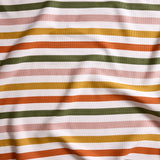 Close up of gently draped striped woven Indoor-Outdoor fabric in white, olive green, pink, mustard yellow and orange.