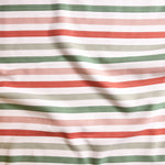 Close up of gently draped striped woven Indoor-Outdoor fabric in white, dark green, pink, coral red and sage green.